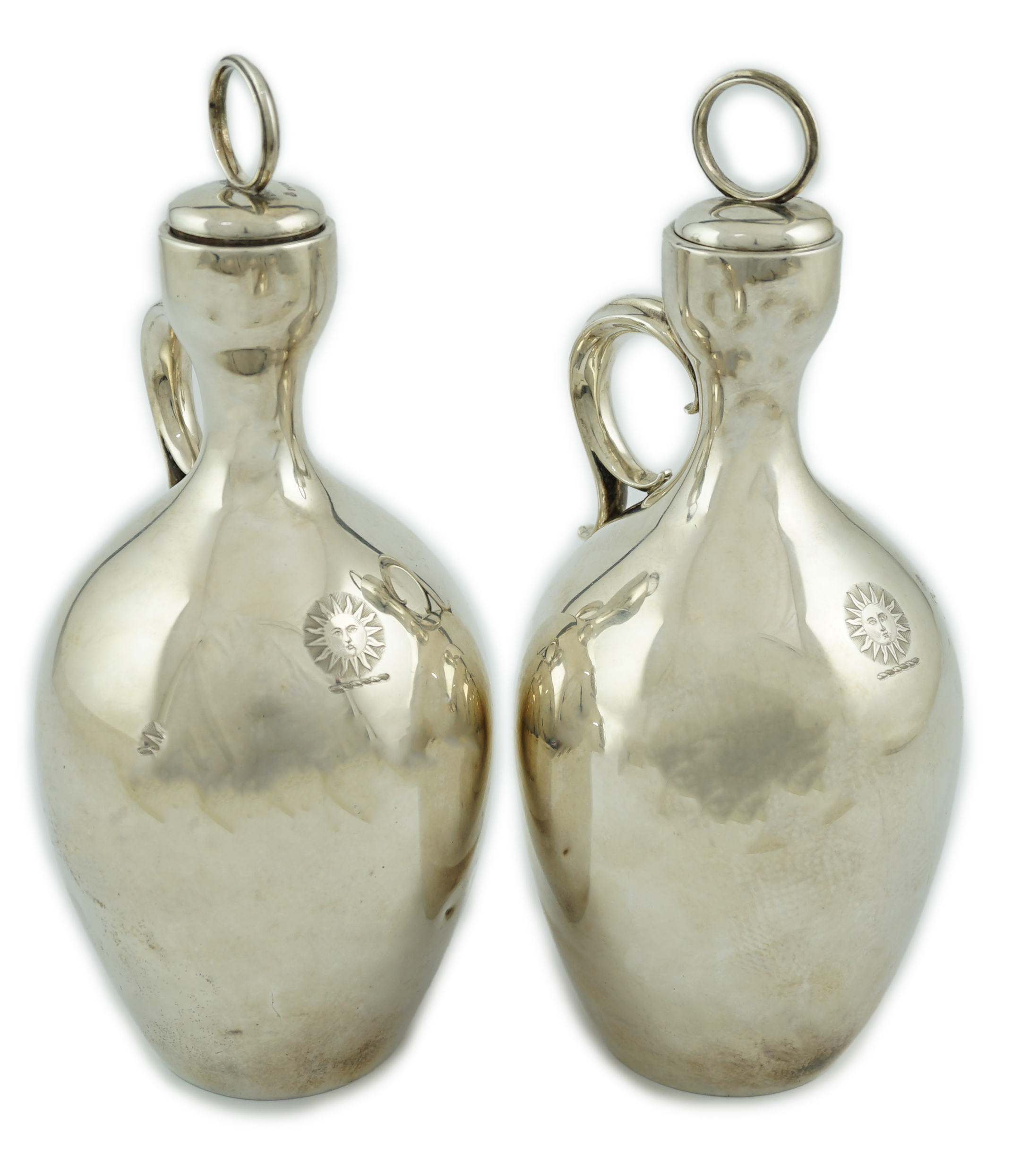 A pair of Victorian silver single handled ovoid water/wine jugs with stoppers, by R & S Garrard & Co